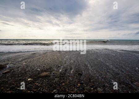 Stormy weather, waves and splashes in Batumi, Georgia. Stormy Black sea. Water background. Stock Photo
