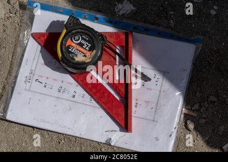 Carpentry measure, plan and design tools on raw wood background. triangular ruler and angle measuring Stock Photo