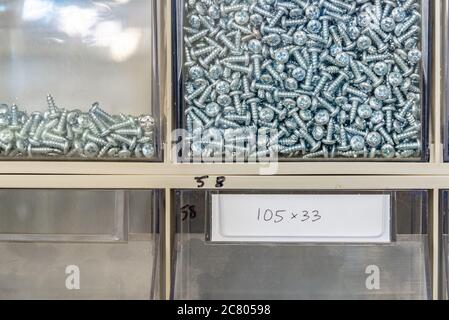 Screws bolts and nuts used in an electrics repairs workshop Stock Photo