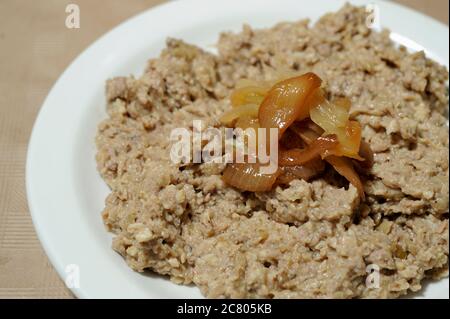 Chopped liver is a spread popular in Ashkenazi Jewish cuisine. made by sauteing or broiling liver and onions in schmaltz (chicken fat) and grinding. Stock Photo