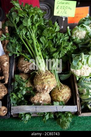 A box of fresh celeriac on a market stall Stock Photo