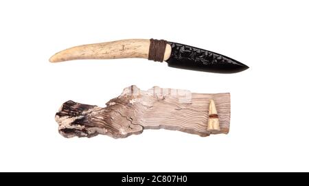 Obsidian knife with bone handle isolate on a white background. Prehistoric weapon made of volcanic glass. Stock Photo