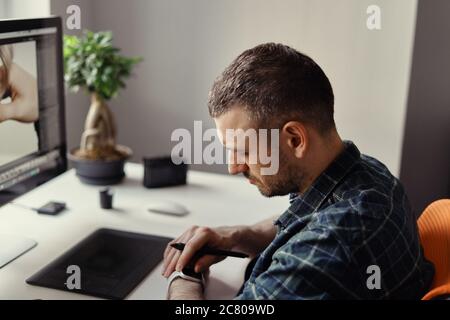 Young man working on his laptop with blank copy space screen for your advertising text message at home. Home office Stock Photo