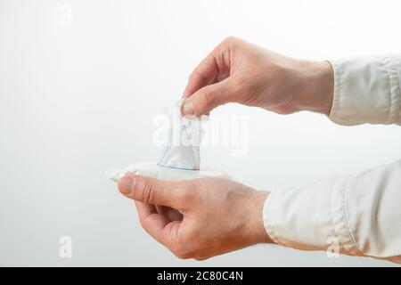 Man hand picked a wet wipes in package box. Stock Photo