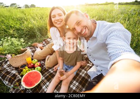 Happy loving family taking selfie in the countryside Stock Photo