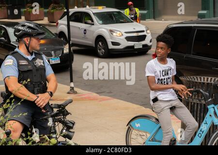 Chicago, IL, USA. 18th July, 2020. A Chicago police officer tries to speak to a teenager in Chicago during a protest in Chicago on July 18, 2020. Credit: Dominic Gwinn/ZUMA Wire/Alamy Live News Stock Photo
