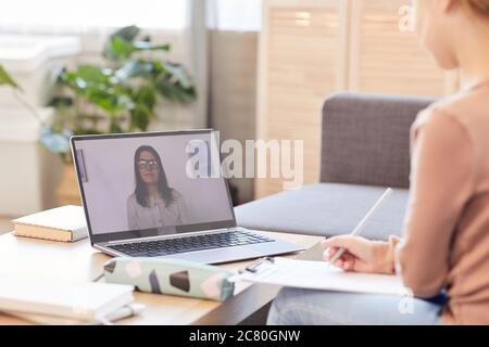 Portrait of unrecognizable child watching online lesson or online class while studying at home via laptop, copy space Stock Photo