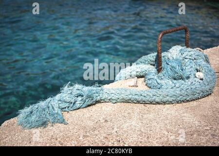 Close-up photo of light blue fishing ropes on the waterfront. Stock Photo