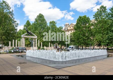 The controversial World War II German occupation memorial on Szabadsag ter in Budapest, Hungary with a fountain before it Stock Photo