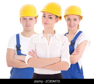 team work concept - two young women and man in blue builder 's uniform isolated on white background Stock Photo