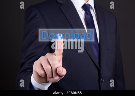 businessman hand pressing download button over dark background Stock Photo