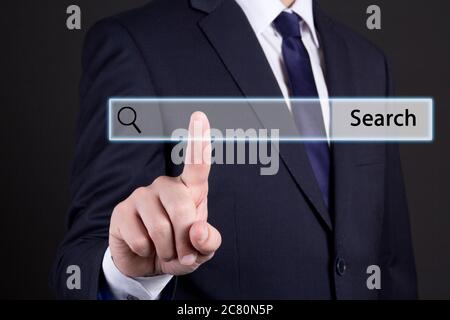 business man clicking internet search page on computer touch screen Stock Photo