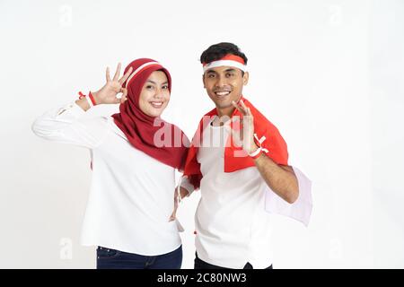 indonesian couple celebrating indonesia independence day together over white background Stock Photo