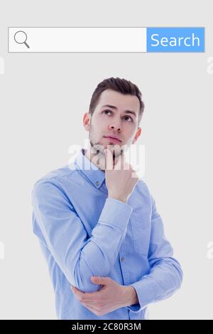 internet search concept - portrait of young man thinking about something over white background Stock Photo