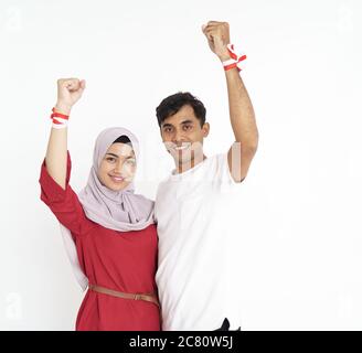indonesian couple celebrating indonesia independence day together over white background Stock Photo