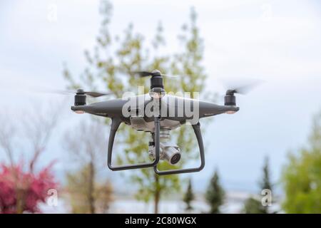 Flying Drone With Camera On The Sky. drones using for most range purpose. One of them is taking photo or video on the sky Stock Photo
