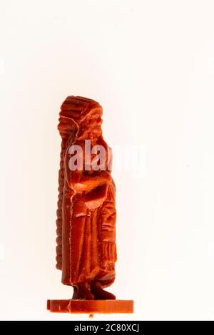 Airfix HO/00 scale model Indian figure from the 1960's against plain background. Close up of standing Indian chief with full length feather bonnet. Stock Photo