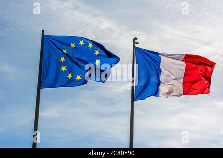 View of French and European Union flags waving beside palm trees and ...