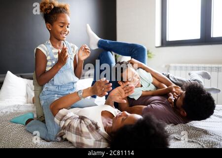 Happy african family enjoying spending time together at home. Stock Photo