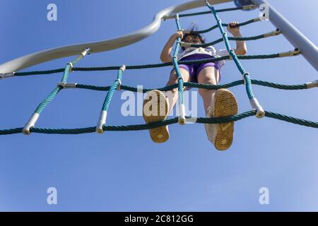 Teenage girl is playing at the playpen Stock Photo