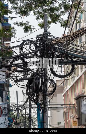Electric tangled wires and cables in a street of Yangon, Burma, Myanmar Stock Photo