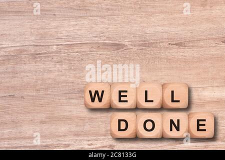 well done written on wooden cubes Stock Photo