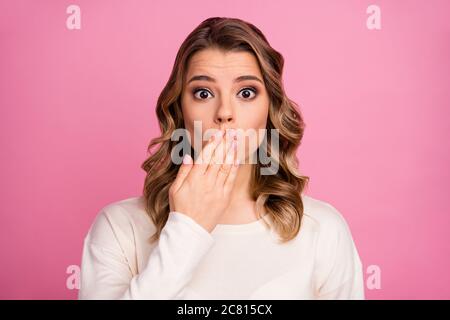 Close-up portrait of her she nice-looking attractive lovely pretty charming confused wavy-haired girl closing mouth awkward news isolated over pink Stock Photo