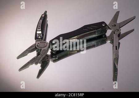 grey swiss knife isolated on white background Stock Photo