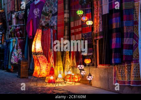Granada lamps, traditional and modern Turkish, Arab & Moroccan lamp & lanterns for sale alongside textiles in a street market in  Albaicin  Granada Stock Photo