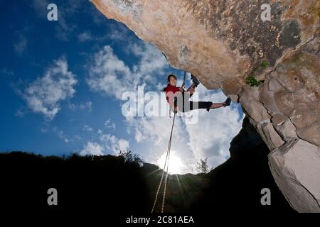 Woman rappelling from cliff in Swanage / UK Stock Photo