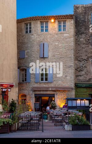 Twilight over an outdoor cafe in Gordes, Provence, France Stock Photo