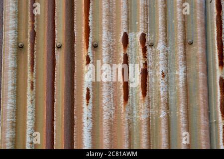 Corroded corrugated metal shutters, with paint rust  and  weathered texture for backgrounds and graphic resources Stock Photo