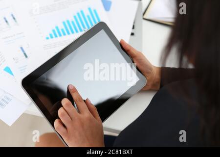 Businesswoman using touchpad while working in office Stock Photo