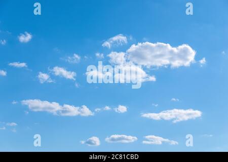 few random white clouds in blue sky, partly cloudiness Stock Photo