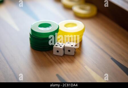 Backgammon, playing an ancient table game. Dice and chips on the backgammon board. Strategy and luck, leisure, entertainment concept. Stock Photo