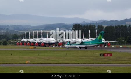 Glasgow, Scotland, UK. 20th July, 2020. Pictured: Aer Lingus flight from Dublin seen at Glasgow Airport with a large group of grounded British Airways (BA) airbus aircraft in the background. Credit: Colin Fisher/Alamy Live News Stock Photo