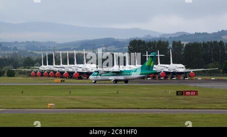 Glasgow, Scotland, UK. 20th July, 2020. Pictured: Aer Lingus flight from Dublin seen at Glasgow Airport with a large group of grounded British Airways (BA) airbus aircraft in the background. Credit: Colin Fisher/Alamy Live News Stock Photo