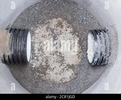 Construction of sewage engineering structures for the drain of sanitary water and rainwater, industry. Plastic pipes in the sewage system in reinforce Stock Photo