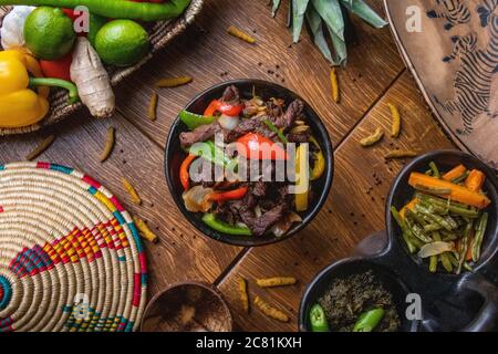 High angle shot of delicious traditional Ethiopian food with vegetables on a wooden surface Stock Photo