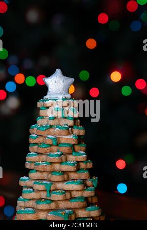 homemade cookies stacked to form a christmas tree with a star on top, decorated for the christmas party Stock Photo