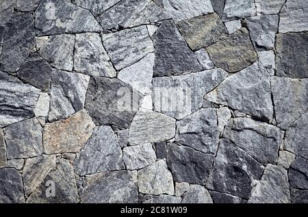 Wallpaper made of marble pieces of various shapes and sizes, rough surface texture or background. Stock Photo