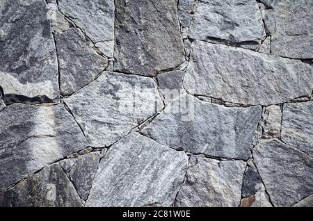 Wallpaper made of marble pieces of various shapes and sizes, rough surface texture or background. Stock Photo