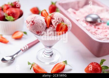 Scooped homemade strawberry ice cream ready to be served. Stock Photo