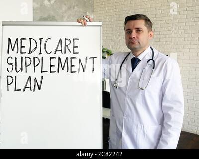 The doctor talks about medicare supplement plan. Stock Photo