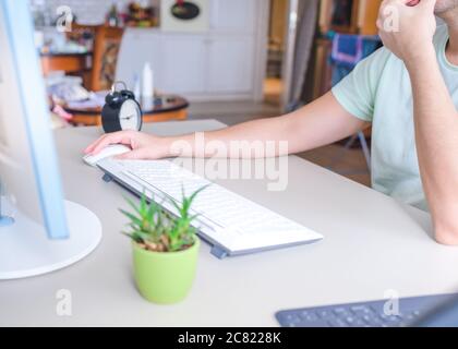 the developer works at the computer, typing, uses the mouse. Selective focus Stock Photo