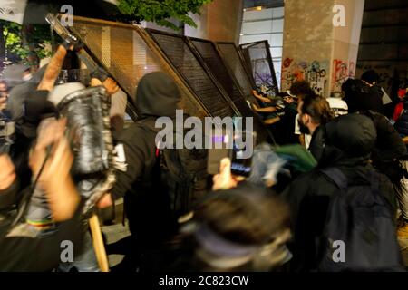 Portland, USA. 19th July, 2020. Protesters dismantle a fence at ...