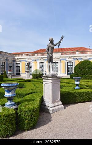 Queluz, Portugal - June 3, 2017: Neptune gardens, sculpture Summer by sculptor John Cheere  and the facades of the Queluz Royal Palace Stock Photo