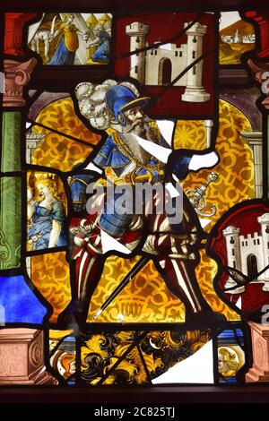 Stunning stained glass window on the wall in the palace of Pena, Sintra, Portugal. Colored pictures from the history of Portugal Stock Photo