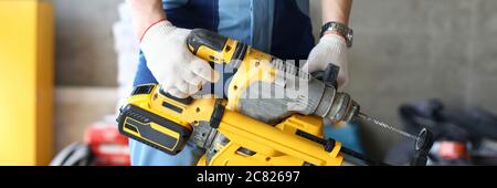 Builder holding perforator instrument in hand Stock Photo