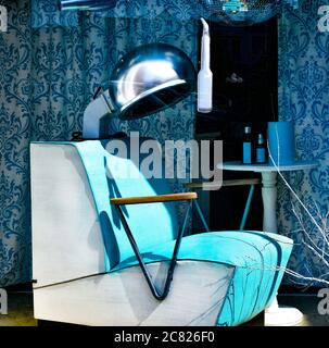 A retro blue Beauty Salon style seat with hair dryer in window display for Trendz Hair Salon, on the square in historic downtown Lebanon, TN Stock Photo